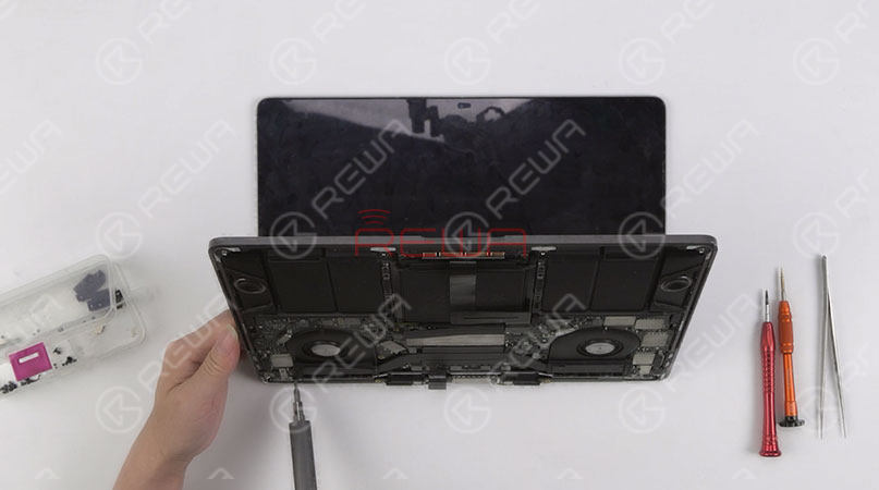 Continue to remove screws securing the screen. Then separate the display assembly from the bottom half keyboard. 